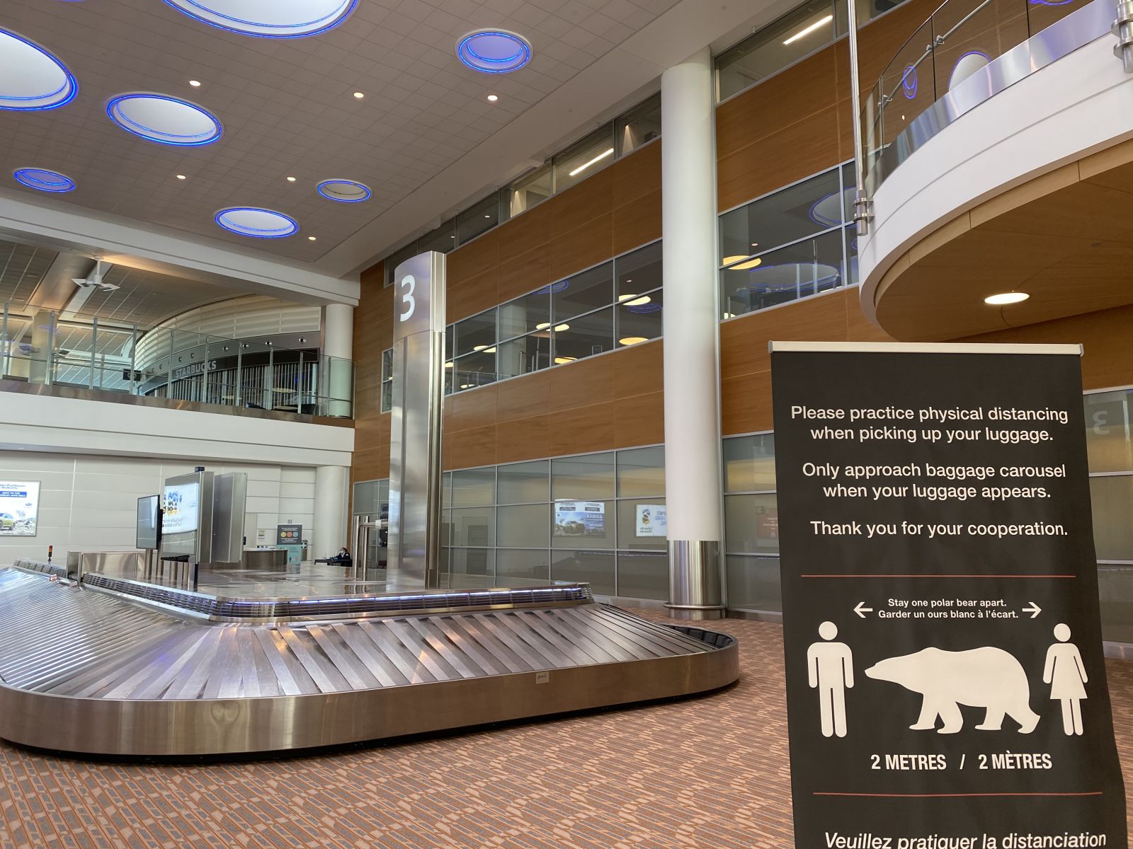 Arrivals Hall photo highlighting physical distancing signage