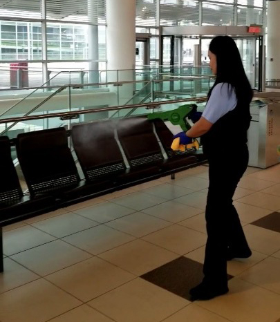 Seating area being disinfected with the electrostatic sprayer tool by member of the cleaning team