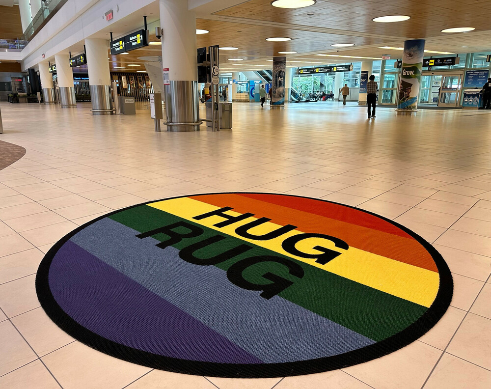 A pride-themed Hug Rug is shown in the Arrivals Hall of Winnipeg Richardson International Airport.